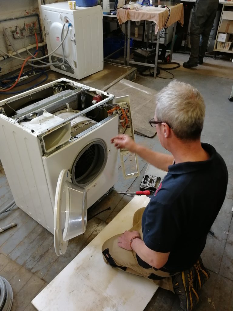 Engineer PAT testing a Washing Machine